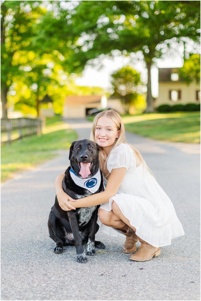 senior pictures on a farm with her dog