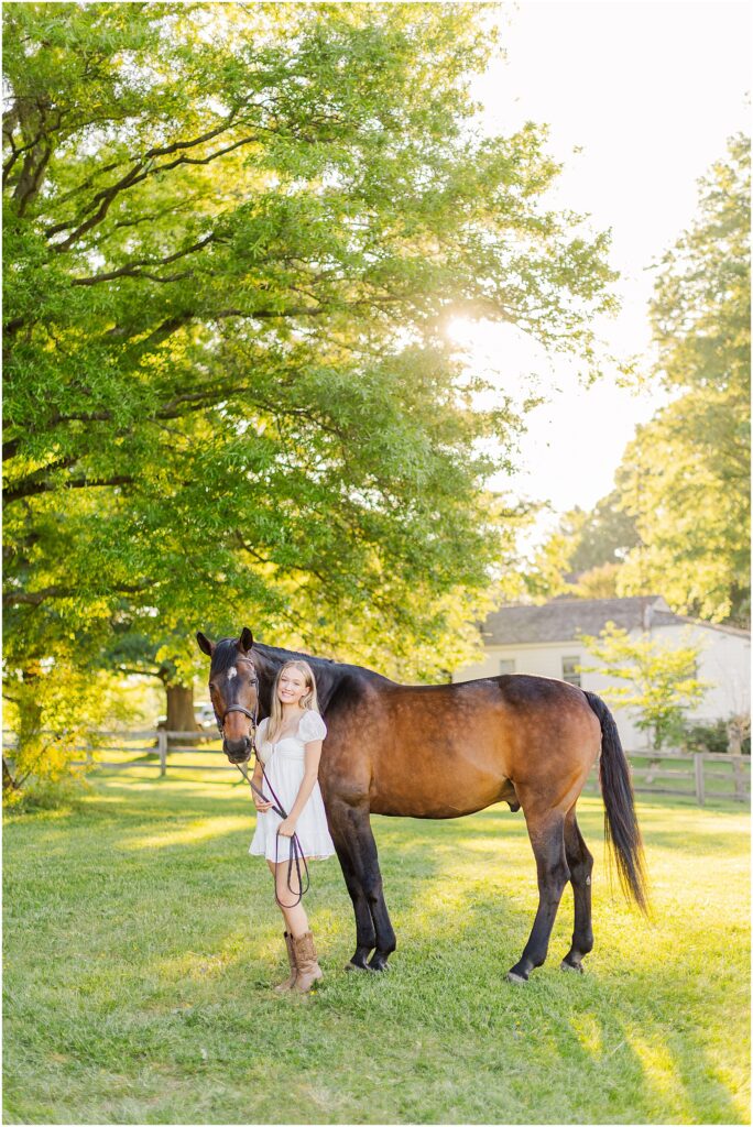 senior pictures with her horse at golden hour on her farm