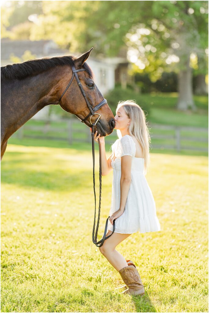 senior pictures with her horse at golden hour on her farm