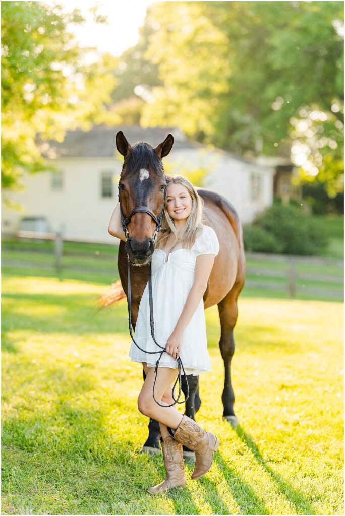 senior pictures with her horse at golden hour on her farm