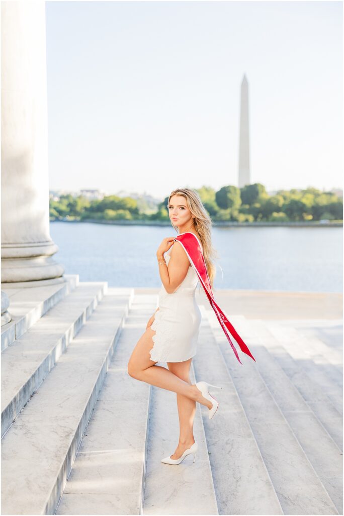 GWU grad pictures on the steps of the Jefferson Memorial