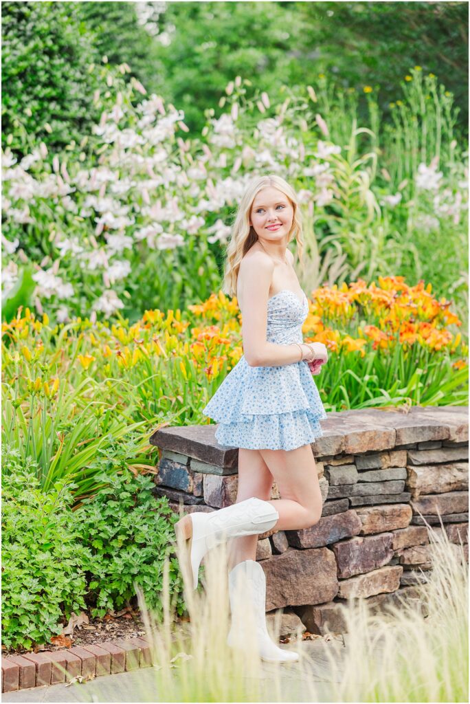 blue romper and white cowgirl boots at pond at Lewis Ginter Botanical Gardens for a summer senior session