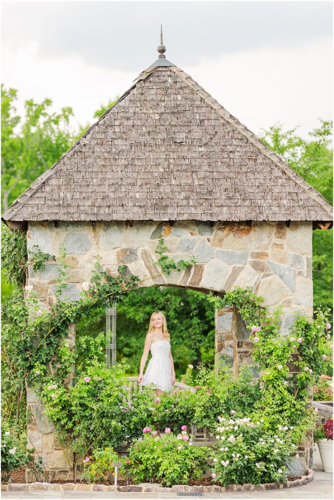 white dress and pink heels for a princess vibe at the rose garden in Lewis Ginter Botanical Gardens for a summer senior session