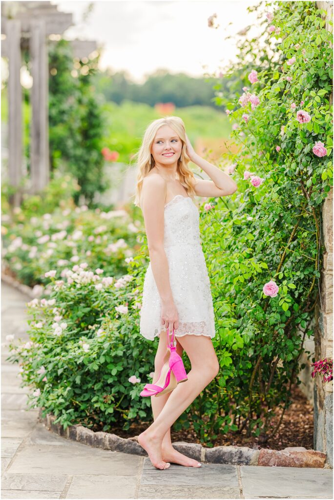 white dress and pink heels for a princess vibe at the rose garden in Lewis Ginter Botanical Gardens for a summer senior session