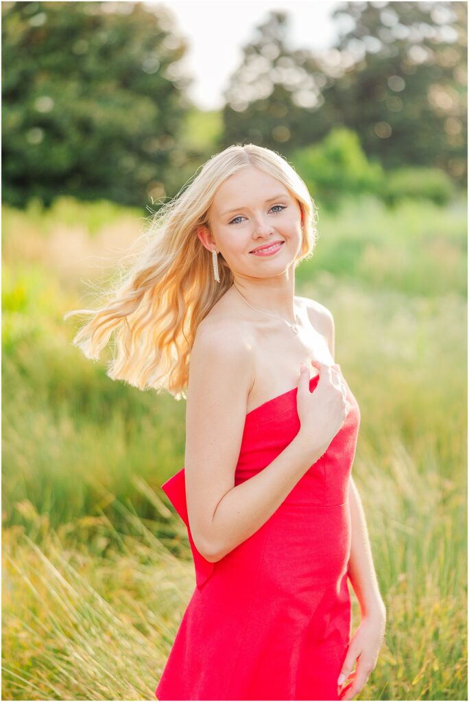 red dress with bow at the conservatory at Lewis Ginter Botanical Gardens for a summer senior session