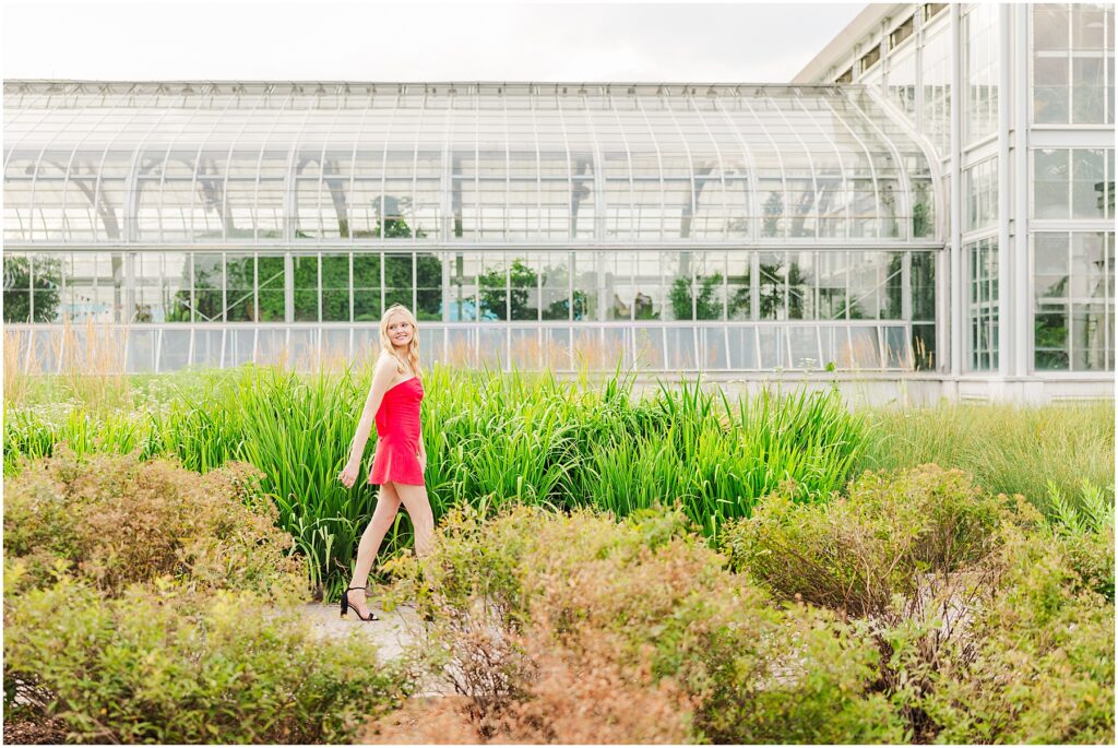 red dress with bow at the conservatory at Lewis Ginter Botanical Gardens for a summer senior session