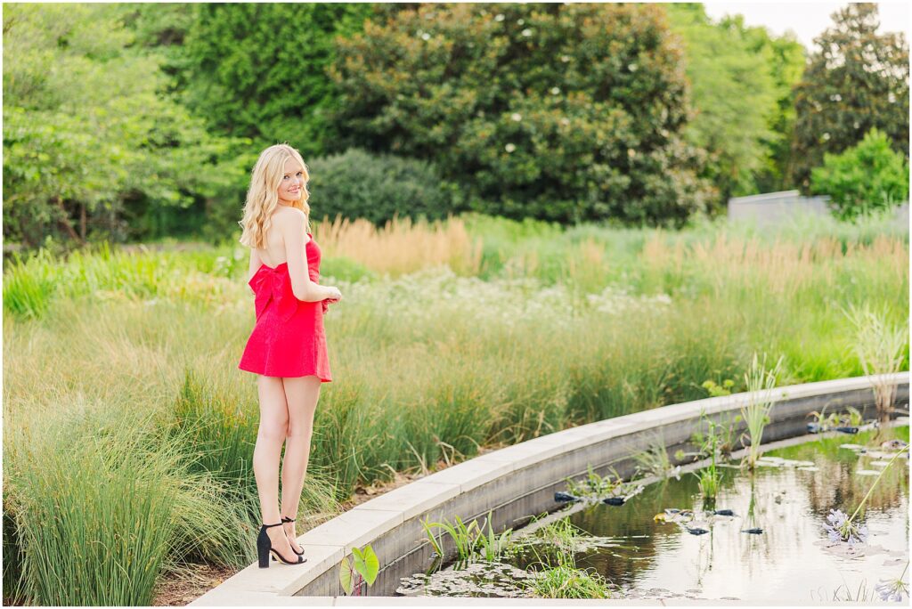 red dress with bow at the conservatory at Lewis Ginter Botanical Gardens for a summer senior session