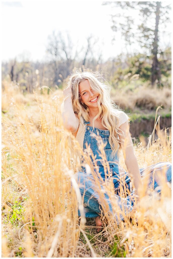 Asia's senior session at Swannanoa wearing overalls in the field