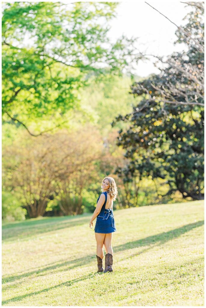 senior pictures at Maymont | denim matching set with an open back and big bow paired with brown cowgirl boots